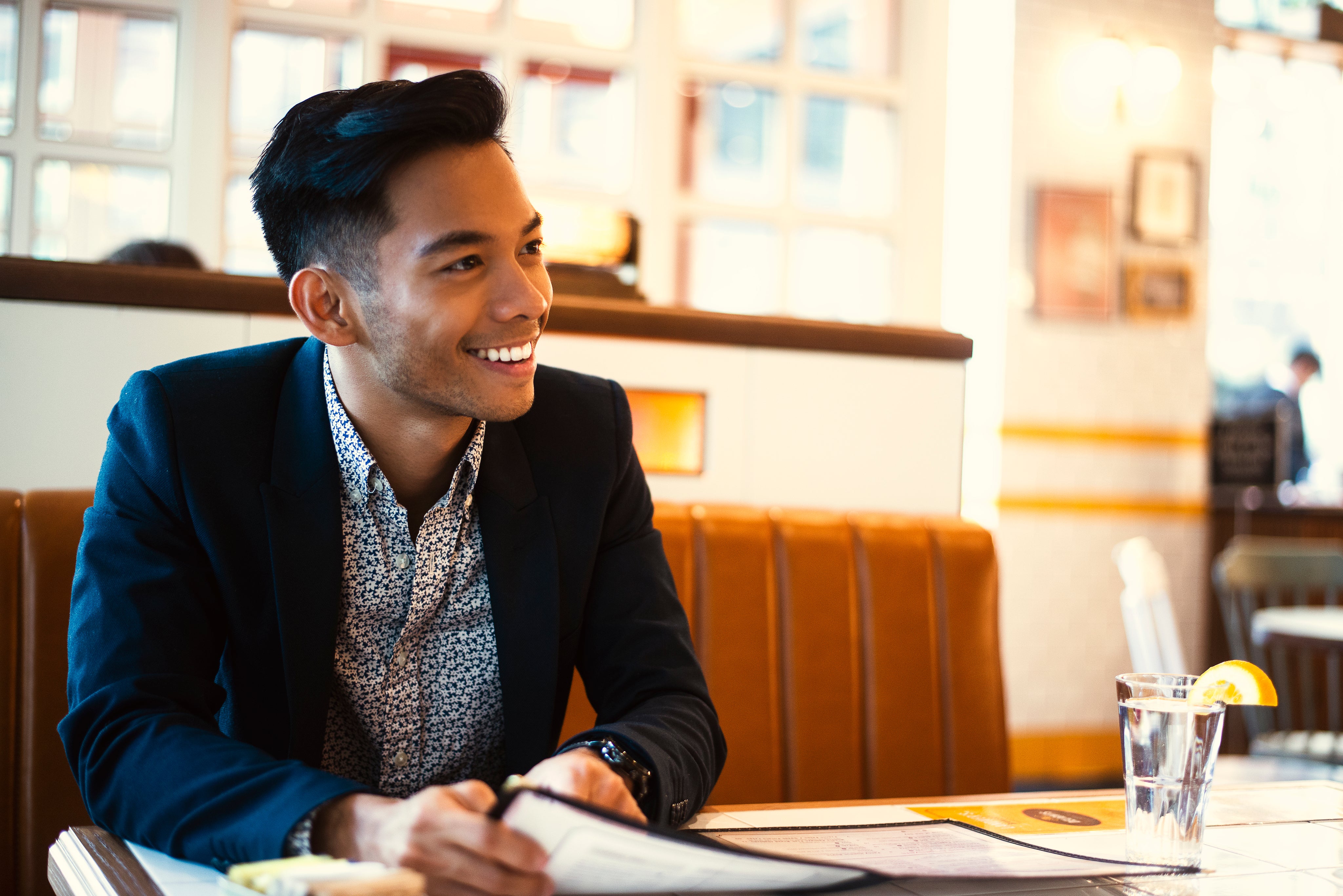 Friendly man smiling from across the table